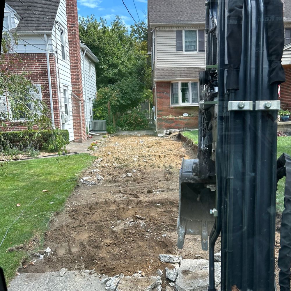 Old walkway excavated with a mini excavator, ready for new hardscape